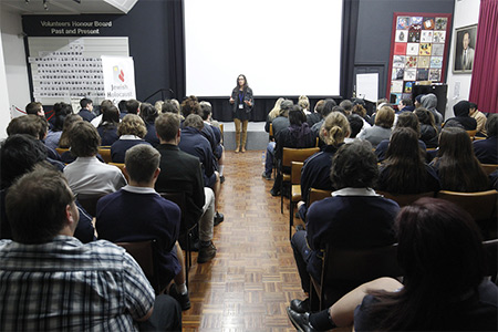 Staff presentation in front of a crowd of listeners